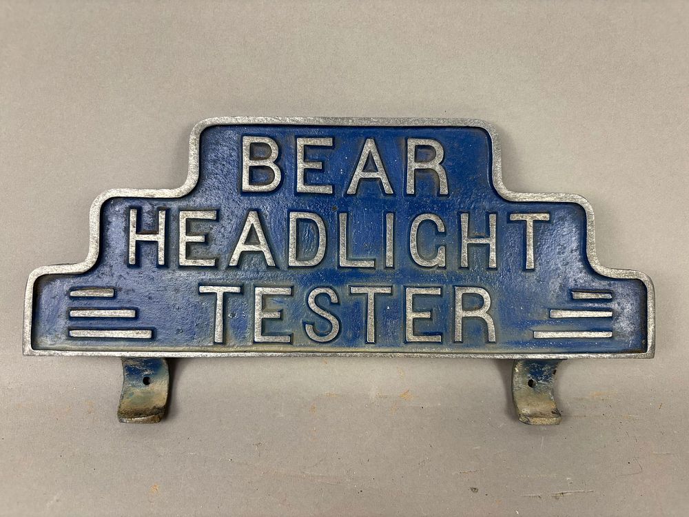 Lot 360J: Bear Headlight Tester Machine Topper Sign