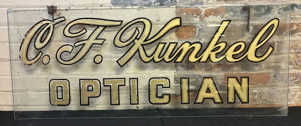 Lot 536: C.F. Kunkel Optician Reverse Painted Glass Gold Gilt Sign