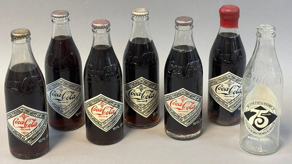 Lot 198: Lot 7 Coca Cola 10 Oz Glass Emboxxed Bottles FULL & Sealed 75th Anniversary