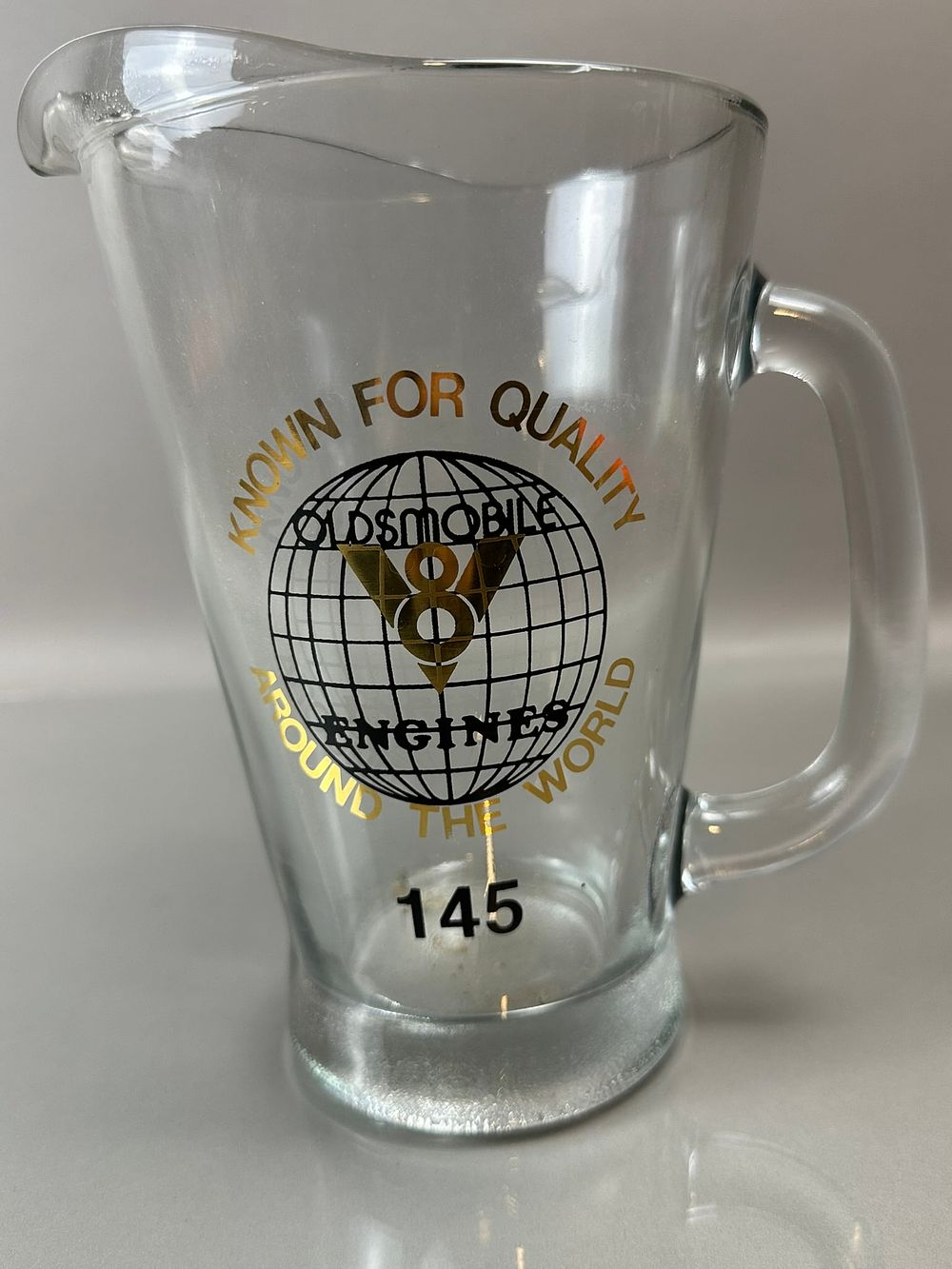 Lot 294B: Oldsmobile V8 Engines Known For Quality Around The World Glass Drink Pitcher