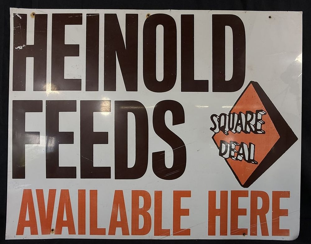 Lot 385: Heinold Feeds Square Deal Available Here SST Metal Sign