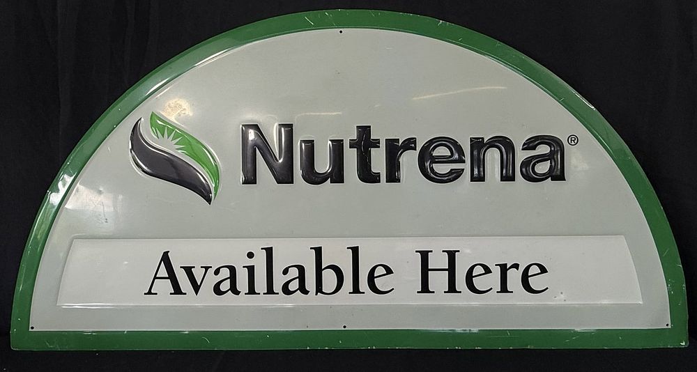 Lot 447: Nutrena Tin Embossed Available Here Painted Metal Farm Sign