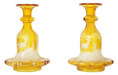 A FINE PAIR OF 19TH CENTURY BOHEMIAN AMBER FLASHED GLASS DECANTERS decorated with Stags amongst 