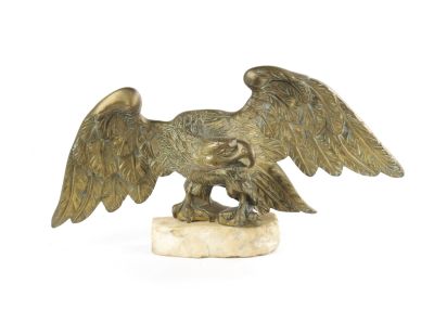 A 19TH CENTURY BRONZE SCULPTURE OF A WINGED EAGLE mounted on a naturalistic white marble base. 