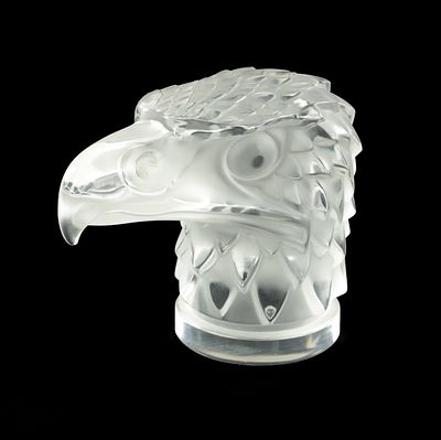 A RENE LALIQUE STYLE 'TETE D'AIGLE' CLEAR AND FROSTED GLASS CAR MASCOT on a circular base 