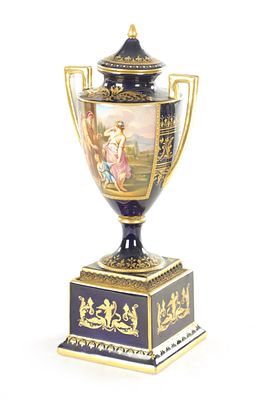 A 19TH CENTURY VIENNA PORCELAIN TWO HANDLED LIDDED URN SHAPED VASE ON PEDESTAL the richly 