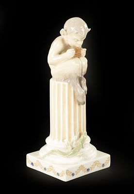 AN EARLY 20TH CENTURY ROYAL COPENHAGEN FIGURE MODELLED AS FAUN ON COLUMNS WITH LIZARD. (21.5cm high)