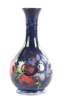 A WALTER MOORCROFT ANEMONE PATTERN BULBOUS VASE with a slender neck and label to under side. 