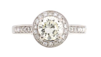 AN 18CT WHITE GOLD AND DIAMOND CLUSTER RING the central claw set 0.85ct brilliant cut diamond 