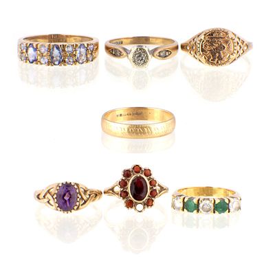 A COLLECTION OF SEVEN 9CT GOLD RINGS, with various stones including amethyst and garnets, total 