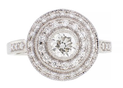 AN 18CT WHITE GOLD AND DIAMOND 'TARGET' CLUSTER RING the round brilliant cut diamond surrounded 