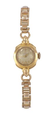A LADIES 18CT GOLD CASED OMEGA WRISTWATCH on a rolled gold bracelet (15mm case)