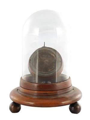 A 18TH CENTURY POCKET WATCH STAND UNDER GLASS DOME, the hinged dome standing on a turned wooden