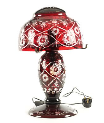 A 2OTH CENTURY BOHEMIAN RUBY RED CUT GLASS LAMP with lattice spiral work floral cut pattern, on 