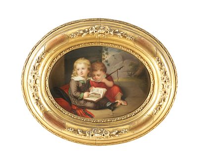 A 19TH CENTURY BERLIN PAINTED PORCELAIN OVAL PLAQUE children reading - in gilt floral moulded 