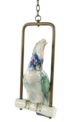 AN EARLY 20TH CENTURY CONTINENTAL PORCELAIN PARROT on a gilt metal mount, formed as a brightly 