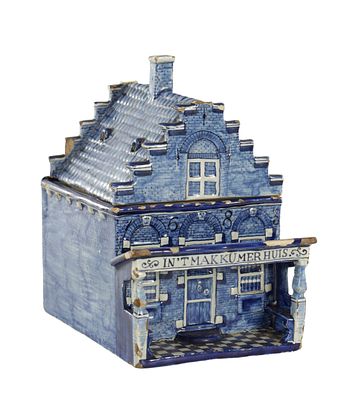A 19TH CENTURY DELFTWARE BLUE AND WHITE TABACCO JAR formed as a Dutch house, inscribed and 