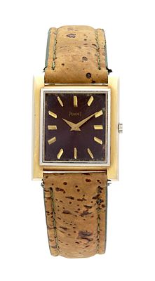 AN 18CT YELLOW AND WHITE GOLD PIAGET MANUAL WIND WRISTWATCH, on a cork-style leather strap. The 