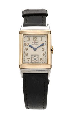 A 1930'S STEEL AND 9CT GOLD LECOULTRE REVERSO WRIST WATCH on a black leather strap, the 