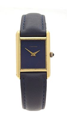 A VINTAGE 18CT GOLD CARTIER MANUAL WIND TANK WATCH on blue leather strap. The rectangular case 