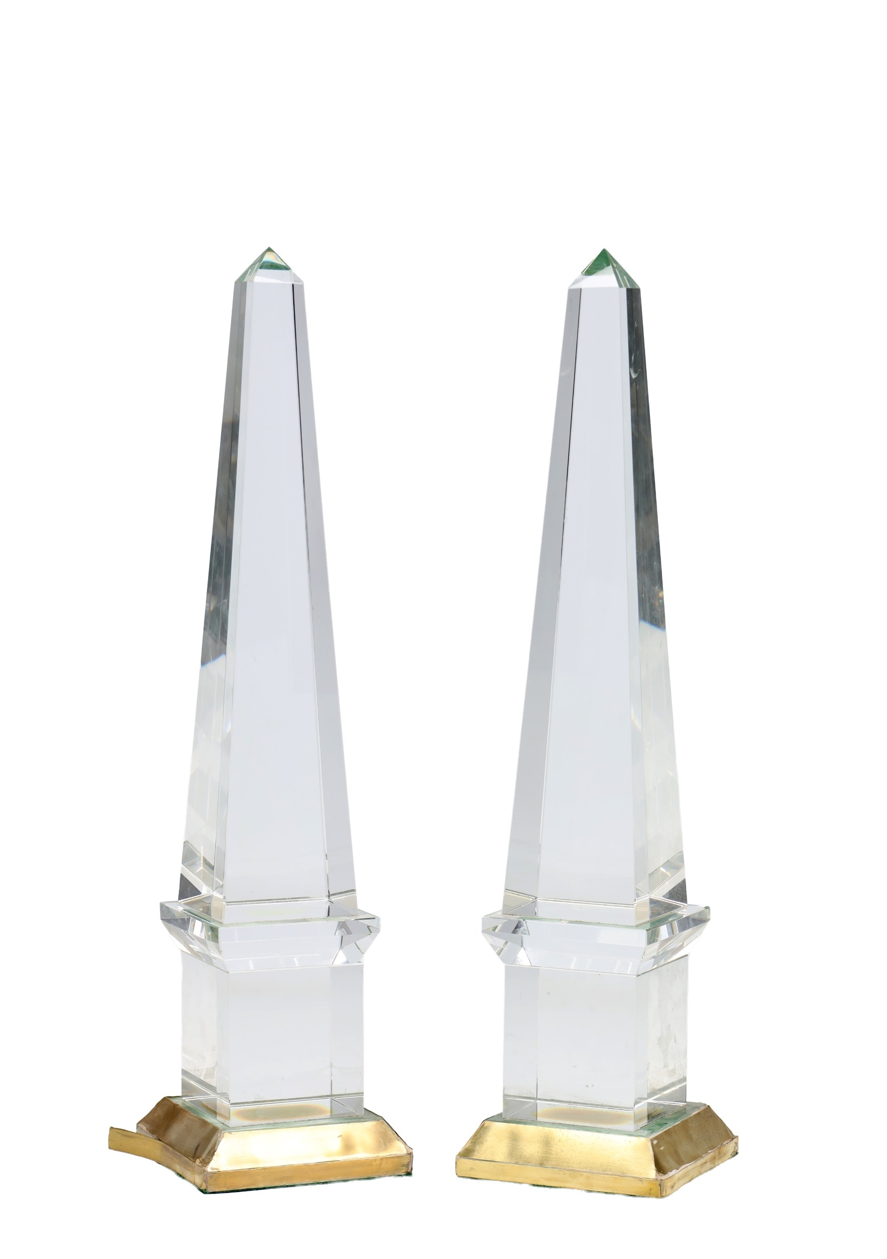 A PAIR OF GLASS OBELISKS of faceted tapering form