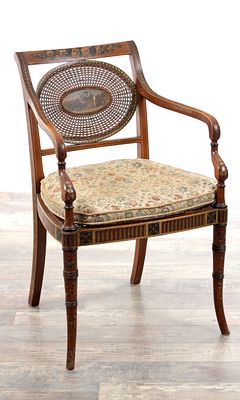 A 19TH CENTURY SHERATON STYLE PAINTED SATINWOOD BERGERE ARMCHAIR with an oval caned panel back 