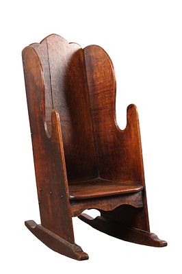 AN EARLY 19TH CENTURY OAK CHILD'S ROCKING CHAIR with a tall arched back with scalloped cresting 