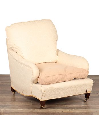AN EARLY 20TH CENTURY HOWARD STYLE UPHOLSTERED ARMCHAIR with loose back and seat cushions 