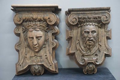 Pair of oak beam soles. Architectural corbels with a detailed depiction of a man and woman. 