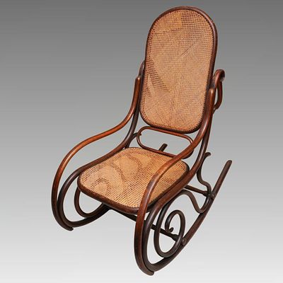 An early 20th Century Michael Thonet style rocking chair, bentwood frame with cane back and 