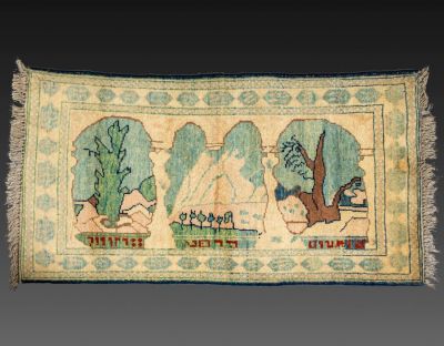 שטיח בסגנון בצלאל. שטיח צמר בסגנון בצלאל, נושא כיתוב בעברית. עיטורים של הר סיני, ועצים. מידות: 