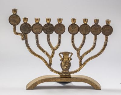 חנוכיית פליז, עשור לישראל. חנוכיית פליז לכבוד עשור למדינת ישראל. מעוטרת במדליונים עם מראה מקומות 