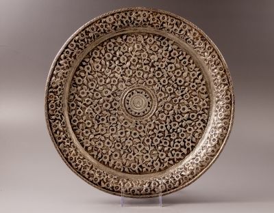 מגש כסף קשמירי. מעוטר בעבודת ריקוע של מוטיבים צמחיים. קוטר: 29.5 ס"מ. משקל: 480 גרם. לא נמצאה 