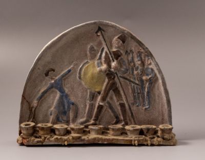 חנוכיית קרמיקה, חוה סמואל. חנוכיית קרמיקה תוצרת כד וספל בעיצוב חוה סמואל, מעוטרת בדמויות של 