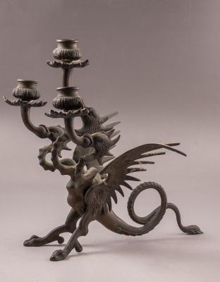 פמוט תלת קני מברונזה בצורת גריפין בעל שלושה ראשים. גובה: 28 ס"מ.