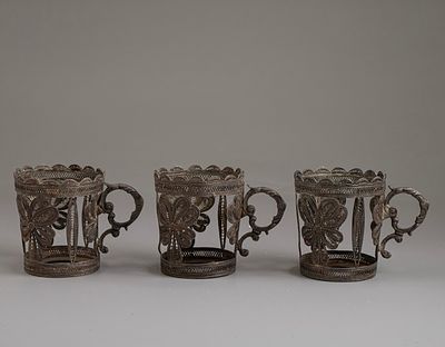 Silver Cup Holders. Set of 3 silver cup holders, decorated with filigree work. Height: 7.5 cm. 