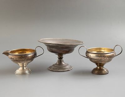 כלי כסף. לוט 3 כלי כסף סטרלינג (מוכבדים), כולל טאצה, כלי לסוכר וחלבייה. גובה: 8.5-9 ס"מ. משקל 