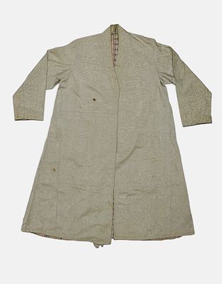 Ethnic Kaftan. Ethnic kaftan, made of light-colored satin fabric with a checkered fabric lining. 