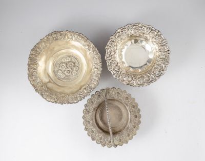לוט קערות כסף. לוט שלוש סלסלות/קערות כסף ניצבות על שלוש רגלים ומעוטרות בתבליטי פרחים וקישוטים. 