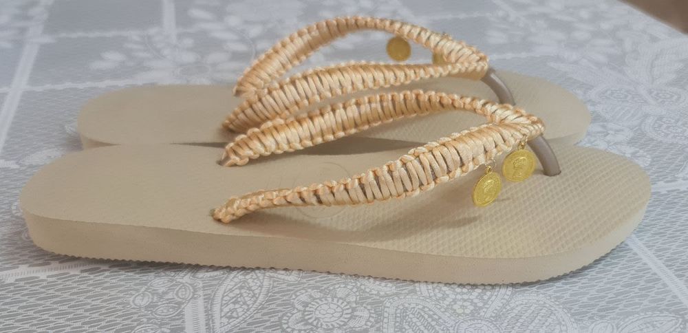 A pair of gold Viens slippers designed by hand with silk threads combined with beauty 