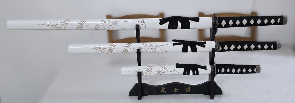 A set of swords on a white wooden stand with decorations for a new home or office buffet, a 