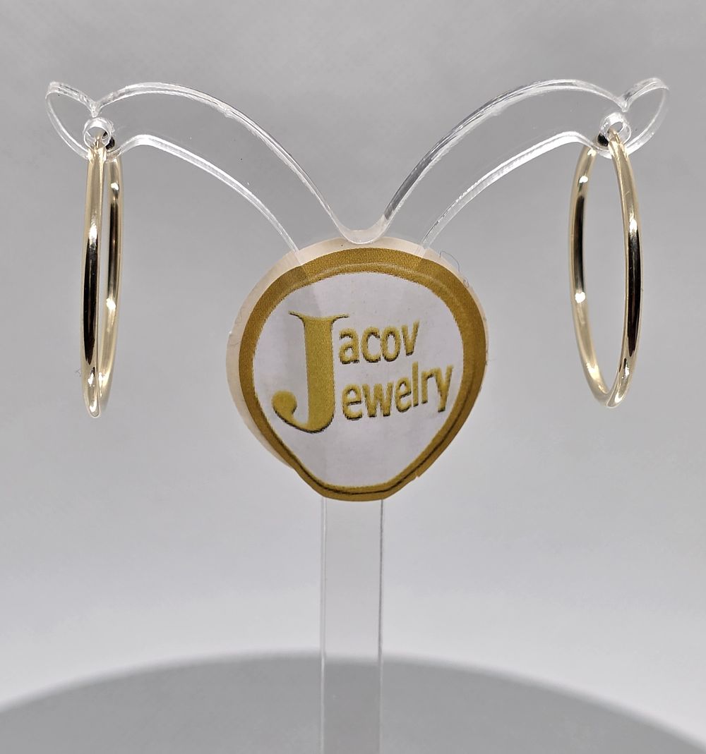 A pair of flexible hollow hoop earrings, diameter 25 mm, 
in 14K yellow gold, new.... Pair of 