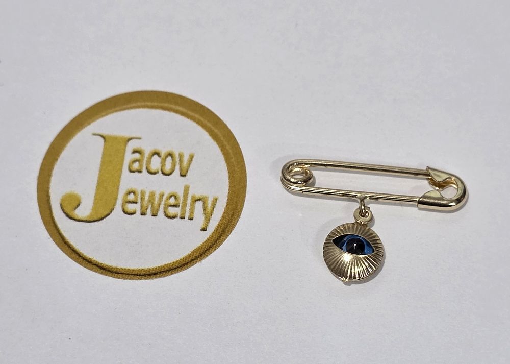 New 14K yellow gold safety pin pendant with eye.... Gold Metal 
Purity: 14K 
Color: Yellow 