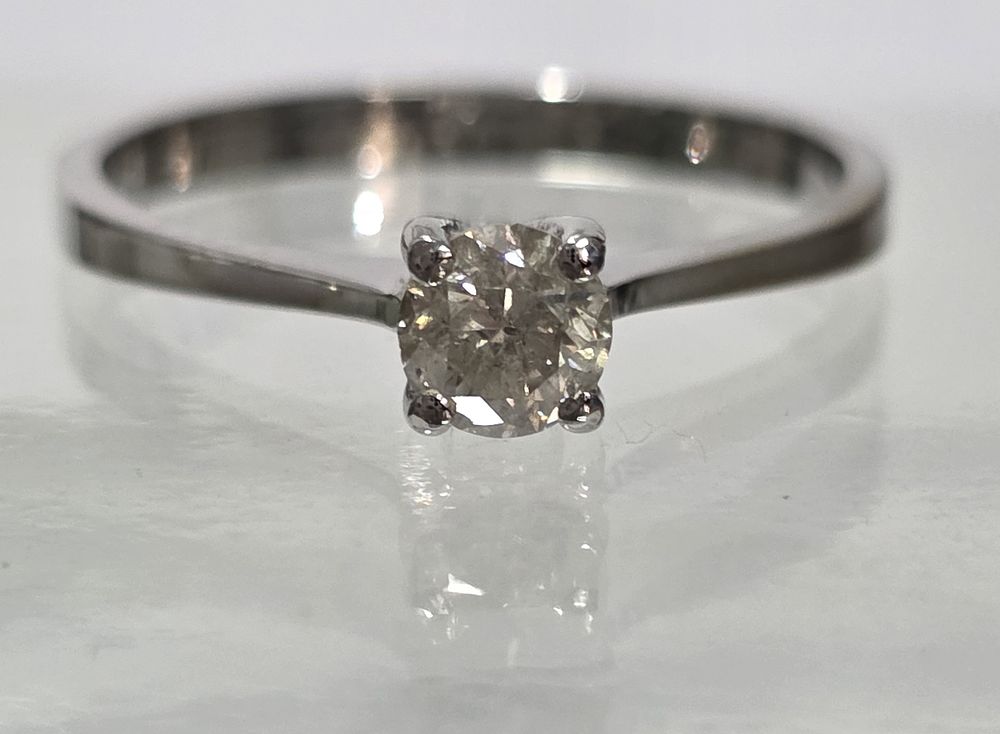0.40ct natural diamond set in a 14K white gold ring
There is a loss of color in the ring, 
as 