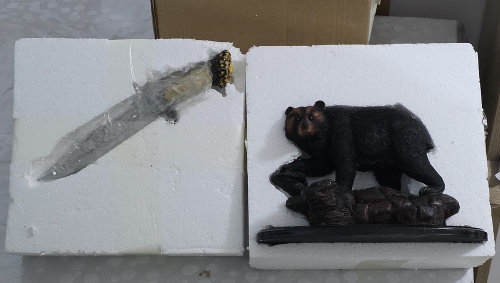 A hunting knife designed on a grizzly bear stand for a new buffet or office Stock is running 