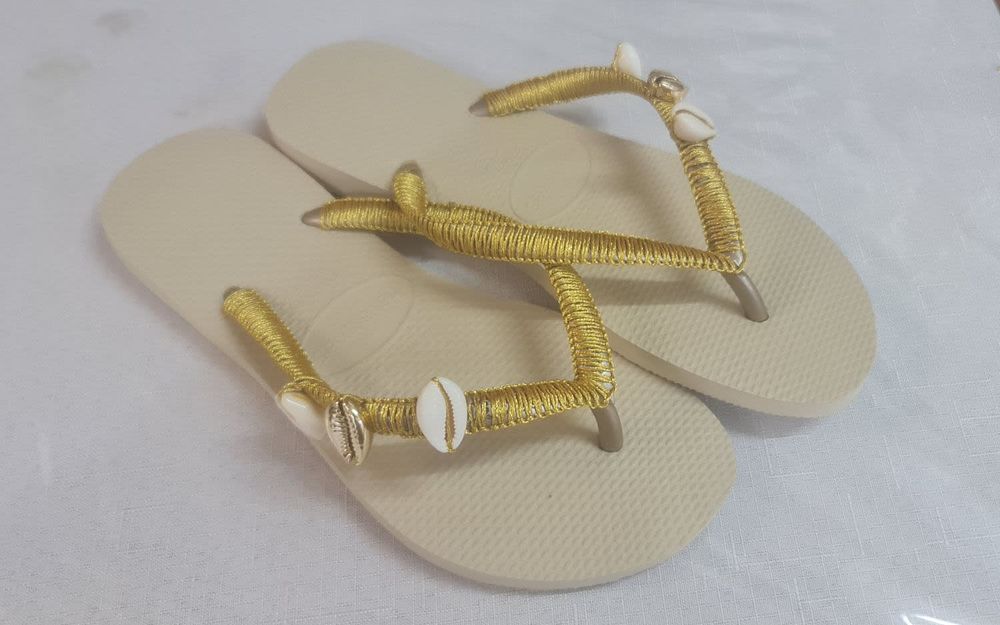 A pair of gold Viens slippers designed by hand with silk threads combined with beauty 