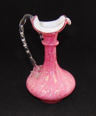 Vintage aventurine glass ewer. Large pink ewer with a tri fold rim adorn with a crimped clear