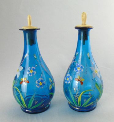 Pair of enameled Barber bottles. Bulbous form in translucent blue glass decorated with enameled