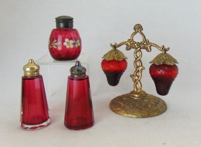Four Cranberry shaker and sets. Including a pair of Ruby strawberry shakers on a metal caddy