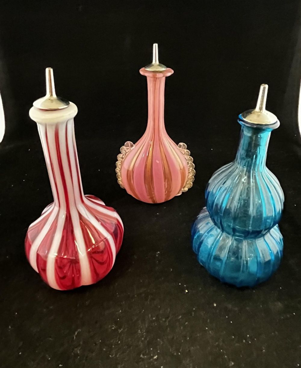 Lot 235: Three art glass barber bottles